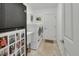 Bright laundry room with front load washer and dryer, utility sink, and tile flooring at 2770 Red Wing Vlg, Deland, FL 32720