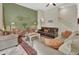 Elegant living room featuring a fireplace, comfortable seating, and a staircase at 2770 Red Wing Vlg, Deland, FL 32720