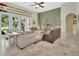 Bright living room with high ceilings, neutral tones, and multiple seating areas at 2770 Red Wing Vlg, Deland, FL 32720
