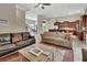 Open concept living room flowing into the kitchen with neutral tones and hardwood floors at 2770 Red Wing Vlg, Deland, FL 32720