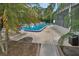 A refreshing community pool featuring ample lounge space surrounded by lush landscaping for a relaxing atmosphere at 2770 Red Wing Vlg, Deland, FL 32720