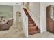 Elegant staircase with wooden steps, white railing, and open access to the living area at 2770 Red Wing Vlg, Deland, FL 32720