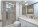 Bright bathroom featuring a glass-enclosed shower, white tile, and a modern sink vanity at 2800 N Atlantic Ave # 1716, Daytona Beach, FL 32118