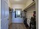 Walk-in closet featuring shelves and storage, with a glimpse into a bedroom through the mirror at 2800 N Atlantic Ave # 1716, Daytona Beach, FL 32118