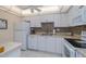 Well-lit kitchen with white cabinets, tiled backsplash, and modern appliances at 2800 N Atlantic Ave # 1716, Daytona Beach, FL 32118