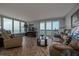 Comfortable living room with floor-to-ceiling windows offering stunning ocean views and balcony access at 2800 N Atlantic Ave # 1716, Daytona Beach, FL 32118