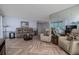 Spacious living room with cozy seating and a large mirror enhancing the natural light at 2800 N Atlantic Ave # 1716, Daytona Beach, FL 32118