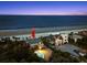 Breathtaking aerial view showcases a beachfront house with a pool, next to the ocean and surrounding properties at 2833 S Atlantic Ave, Daytona Beach, FL 32118