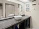 Bathroom featuring double vessel sinks, granite countertop, and large mirror at 2833 S Atlantic Ave, Daytona Beach, FL 32118
