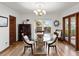 Dining area with glass table, chandelier, and hardwood floors at 2833 S Atlantic Ave, Daytona Beach, FL 32118