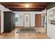 Inviting entryway with wooden ceiling beams, hardwood floors, and direct access to the kitchen at 2833 S Atlantic Ave, Daytona Beach, FL 32118