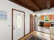 Welcoming entryway with a stained glass front door, hardwood floors, and access to the kitchen at 2833 S Atlantic Ave, Daytona Beach, FL 32118