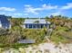 Charming beachfront house with a wooden walkway leading to a dock and a deck at 2833 S Atlantic Ave, Daytona Beach, FL 32118