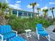 Charming beach house with blue facade, set in the dunes with palm trees and ocean views at 2833 S Atlantic Ave, Daytona Beach, FL 32118