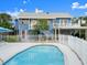 Exterior daytime view of a home featuring a pool, covered carport, and fenced yard at 2833 S Atlantic Ave, Daytona Beach, FL 32118