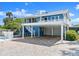 Exterior view of a home featuring a covered carport, garage, and fenced yard at 2833 S Atlantic Ave, Daytona Beach, FL 32118