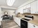 Modern kitchen with white cabinets, granite countertops, and stainless steel appliances at 2833 S Atlantic Ave, Daytona Beach, FL 32118