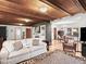Open living room features a comfortable couch, stylish rug, and views of the adjacent dining area at 2833 S Atlantic Ave, Daytona Beach, FL 32118