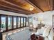 Bright living room with wood ceilings, plush seating, and beach views through large windows at 2833 S Atlantic Ave, Daytona Beach, FL 32118
