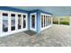 Covered patio with stunning blue exterior and white trim, featuring French doors with beach views at 2833 S Atlantic Ave, Daytona Beach, FL 32118