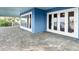 Spacious patio with beautiful brick pavers and white French doors leading inside the home at 2833 S Atlantic Ave, Daytona Beach, FL 32118