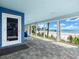 Covered patio with views of the beach and seating area with a blue chair at 2833 S Atlantic Ave, Daytona Beach, FL 32118