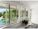Enclosed sunroom featuring large windows with pool view and white trim at 2833 S Atlantic Ave, Daytona Beach, FL 32118