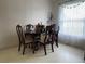 Cozy dining room featuring a wooden table with chairs and natural light streaming through the window at 2875 Delrose N Dr, Lakeland, FL 33805