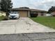 Cozy single-story home with a well-maintained lawn, two-car garage, and lengthy driveway at 2875 Delrose N Dr, Lakeland, FL 33805