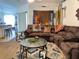 Inviting living room featuring a comfortable brown sectional sofa, round glass tables, and a stylish area rug at 2875 Delrose N Dr, Lakeland, FL 33805