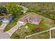 Aerial view of a property featuring a well-maintained lawn, mature trees, and a charming single-story home at 2880 Boyd Ct, Deltona, FL 32738
