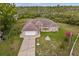 Aerial view of a well-maintained property with a lush lawn, mature trees, and a charming single-story home at 2880 Boyd Ct, Deltona, FL 32738