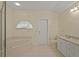 Bright bathroom featuring a corner tub, a large countertop, and a neutral color scheme at 2880 Boyd Ct, Deltona, FL 32738