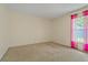 Bedroom with neutral carpet and walls, featuring a large window with privacy sheers at 2880 Boyd Ct, Deltona, FL 32738