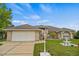 Charming single-Gathering home featuring a well-manicured lawn, complemented by a decorative fountain and brick facade at 2880 Boyd Ct, Deltona, FL 32738
