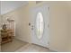 Bright foyer featuring a decorative glass front door and neutral-toned walls, with a glimpse of a tastefully decorated interior at 2880 Boyd Ct, Deltona, FL 32738