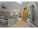 Spacious kitchen with tile flooring, wooden cabinets, stainless steel appliances, and breakfast bar seating at 2880 Boyd Ct, Deltona, FL 32738