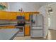Efficient kitchen features oak cabinetry, modern appliances, and a breakfast bar at 2880 Boyd Ct, Deltona, FL 32738