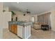 View of the kitchen, with a breakfast bar overlooking a living room with decorative ceiling fan at 2880 Boyd Ct, Deltona, FL 32738