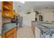 Open kitchen boasts oak cabinets, tile floors, and stainless-steel appliances at 2880 Boyd Ct, Deltona, FL 32738