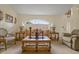 Bright living room with a large arched window, elegant furnishings, and neutral tones at 2880 Boyd Ct, Deltona, FL 32738