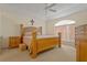 Spacious main bedroom with a decorative window, carpet flooring, and a wooden bed frame at 2880 Boyd Ct, Deltona, FL 32738