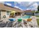 A beautiful backyard offers a sparkling pool, solar panels, and comfortable lounge chairs at 307 Ravenshill Way, Deland, FL 32724