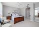Airy bedroom boasts a ceiling fan, warm natural light, soft neutral walls and carpet at 307 Ravenshill Way, Deland, FL 32724