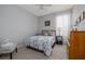 Comfortable bedroom with bright natural light, and features a full size bed, side table, and dresser at 307 Ravenshill Way, Deland, FL 32724