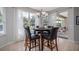 Sunlit breakfast nook with a glass table set and backyard views, perfect for casual dining and relaxation at 307 Ravenshill Way, Deland, FL 32724