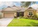Charming single-story home with a well-maintained lawn and attached two-car garage in a suburban neighborhood at 307 Ravenshill Way, Deland, FL 32724