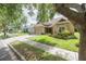 Attractive curb appeal with a manicured lawn, mature landscaping, and a charming single story residence at 307 Ravenshill Way, Deland, FL 32724