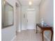 Bright foyer featuring tile flooring, a decorative table, and neutral paint, creating a welcoming entrance at 307 Ravenshill Way, Deland, FL 32724