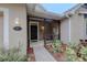 Inviting covered front porch with a seating area, decorative plants, and a stylish entrance to the home at 307 Ravenshill Way, Deland, FL 32724
